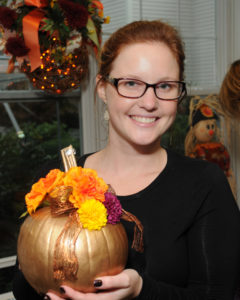 Admissions Director for Harborview Center for Nursing and Rehabilitation in Cohasset holds her pumpkin, during the professional networking Halloween event at Allerton House Assisted Living in Hingham.