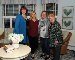 Gathering for a group photo in one of the newly renovated common areas are: Carol Taylor, marketing director, Allerton House in Hingham; Emily Bane, director of marketing and communications, BaneCareSouth, which includes the Harbor House Rehab Center in Hingham; Carolyn Walsh, CMC, CDP, certified geriatric care manager, Senior Steps; and Lynda Chuckran, director, community relations, Welch Senior Living.