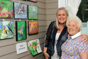 Resident Irene Jefferson and her daughter Carol Ribuado enjoy the varied entries Irene placed in the annual Art Show of the Memory Care Neighborhood at Allerton House in Hingham.