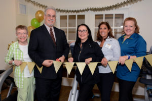 It’s official. Allerton House in Hingham celebrated the opening of the community’s new Fitness Center with great fanfare. Cutting the ribbon (from left to right) are resident Betty Lincoln; Tom Karnes, executive director; Kim Vallantini, activity director: Mandy Mahoney, activity assistant; and Janeen Cullihane, activity assistant.