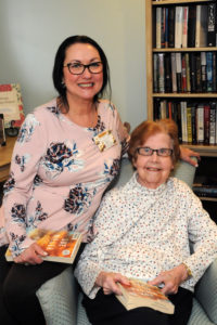 Activity Director Kimberly Vallatini and resident Shirley Connolly get ready for an interesting Book Club discussion.