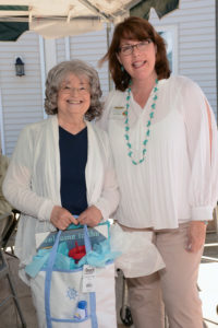Marketing Director Carol Taylor stands with Hingham Council on Aging attendee Lonnie Cutler, proud recipient of a summer tote filled with goodies for the beach!