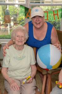 Allerton House in Hingham and an activity assistant enjoying fun at the Beach Party