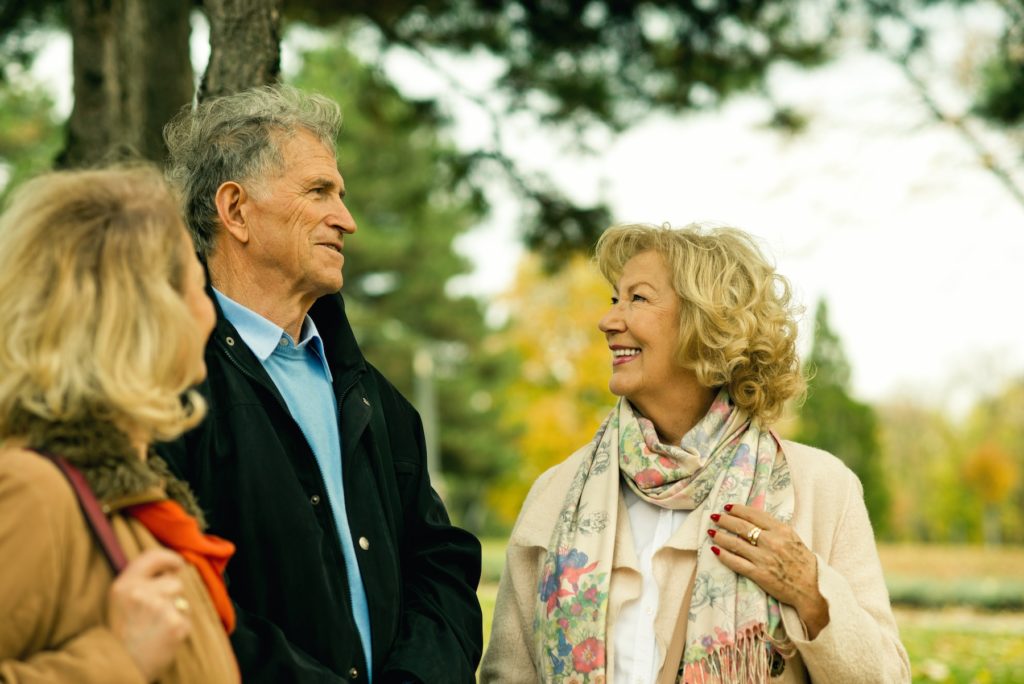Group of happy seniors talking at the park