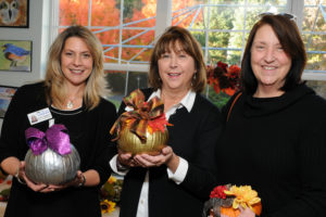 Professionals at a networking event with decorated pumpkins