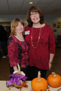 Carol Taylor, marketing director, Allerton House at Harbor Park greets Denise Conley, a social worker for Queen Anne Nursing Home in Hingham.