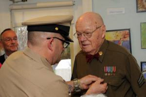 Army veteran and Allerton House resident receives a pin for Veterans Day