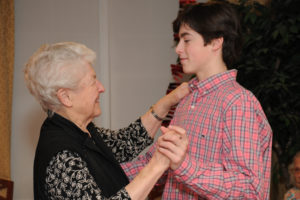 Resident Florence Dearing takes a few ballroom dance steps with volunteer Bobby Falvey from Hingham High School.