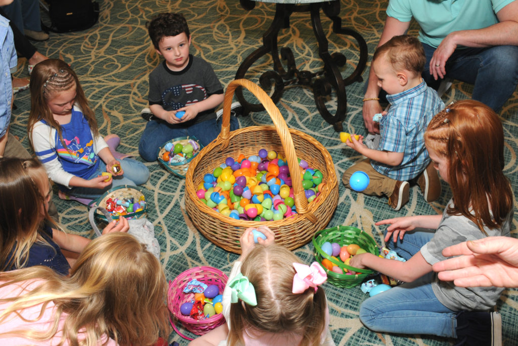 Young children with a big basket of plastic Easter eggs