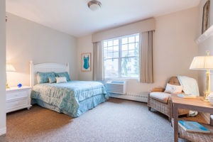 Bedroom with queen-sized bed in senior living apartment
