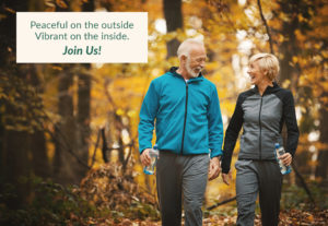 Older couple walking in the woods, with the words peaceful on the outside, vibrant on the inside, join us!