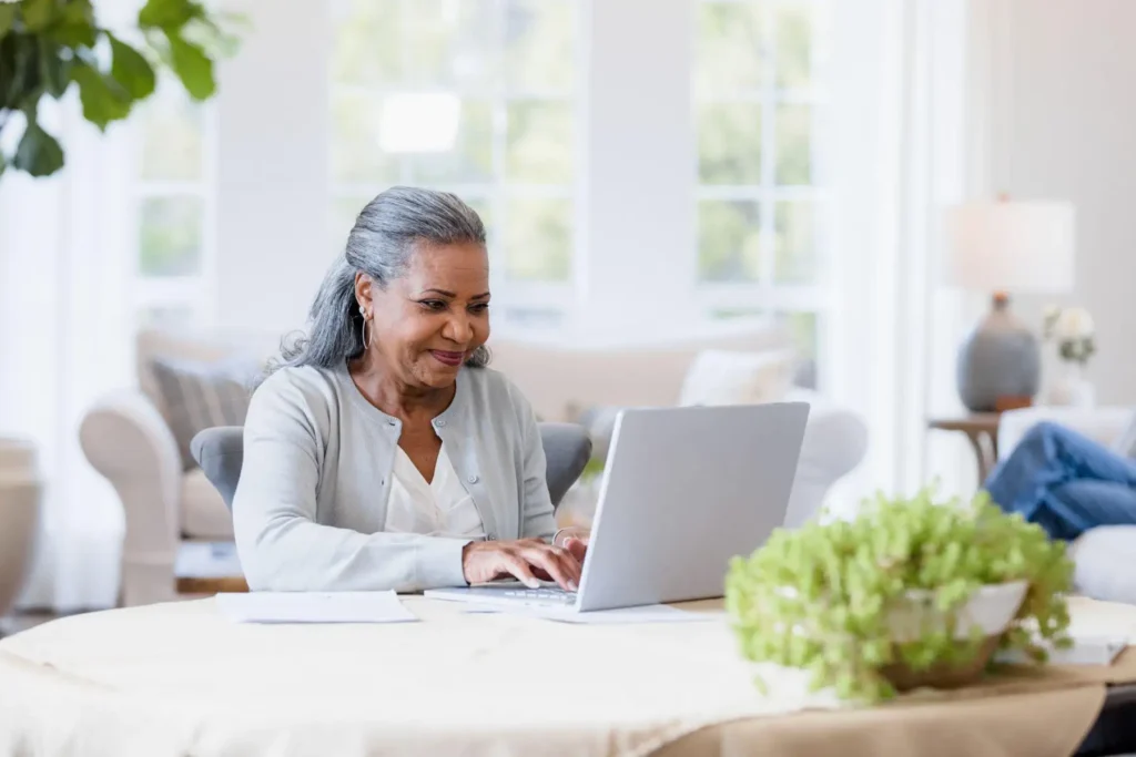 a senior woman working on her computer