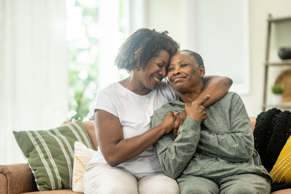 adult woman hugging senior mom